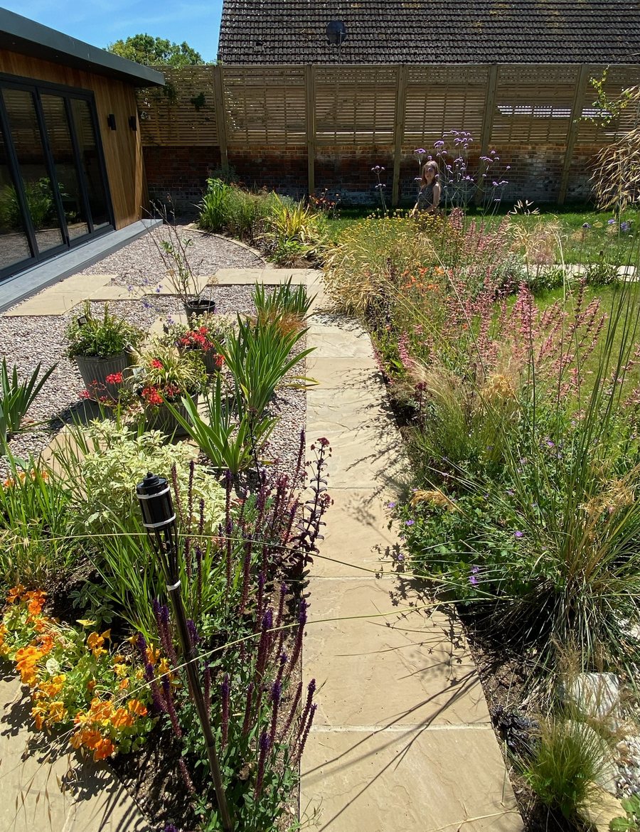 Barn Courtyard Garden in An outdoor room with a fire bowl